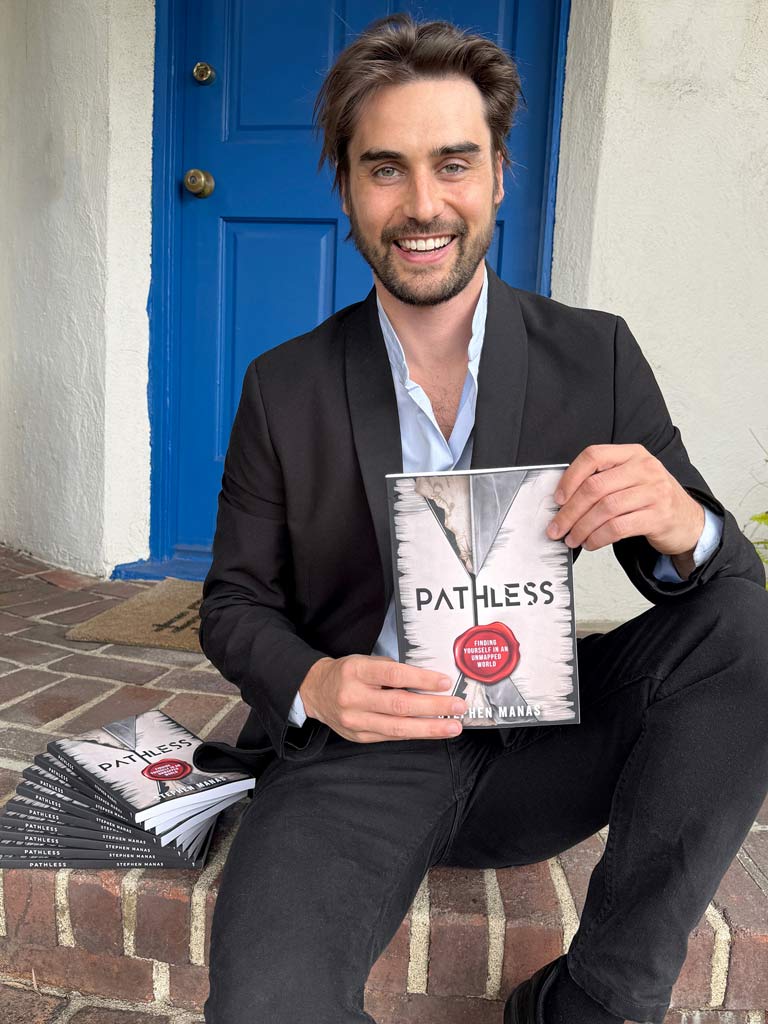 Stephen Manas holding book