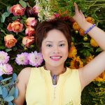 Helen Ye Plehn laying in flowers