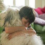 boy hugging dog